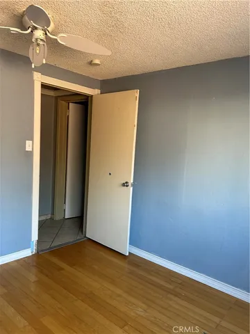 an empty room with wooden floor and closet