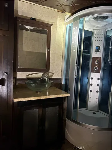 a bathroom with mirror on the door