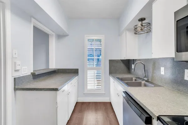 a kitchen with stainless steel appliances granite countertop a sink stove and cabinets