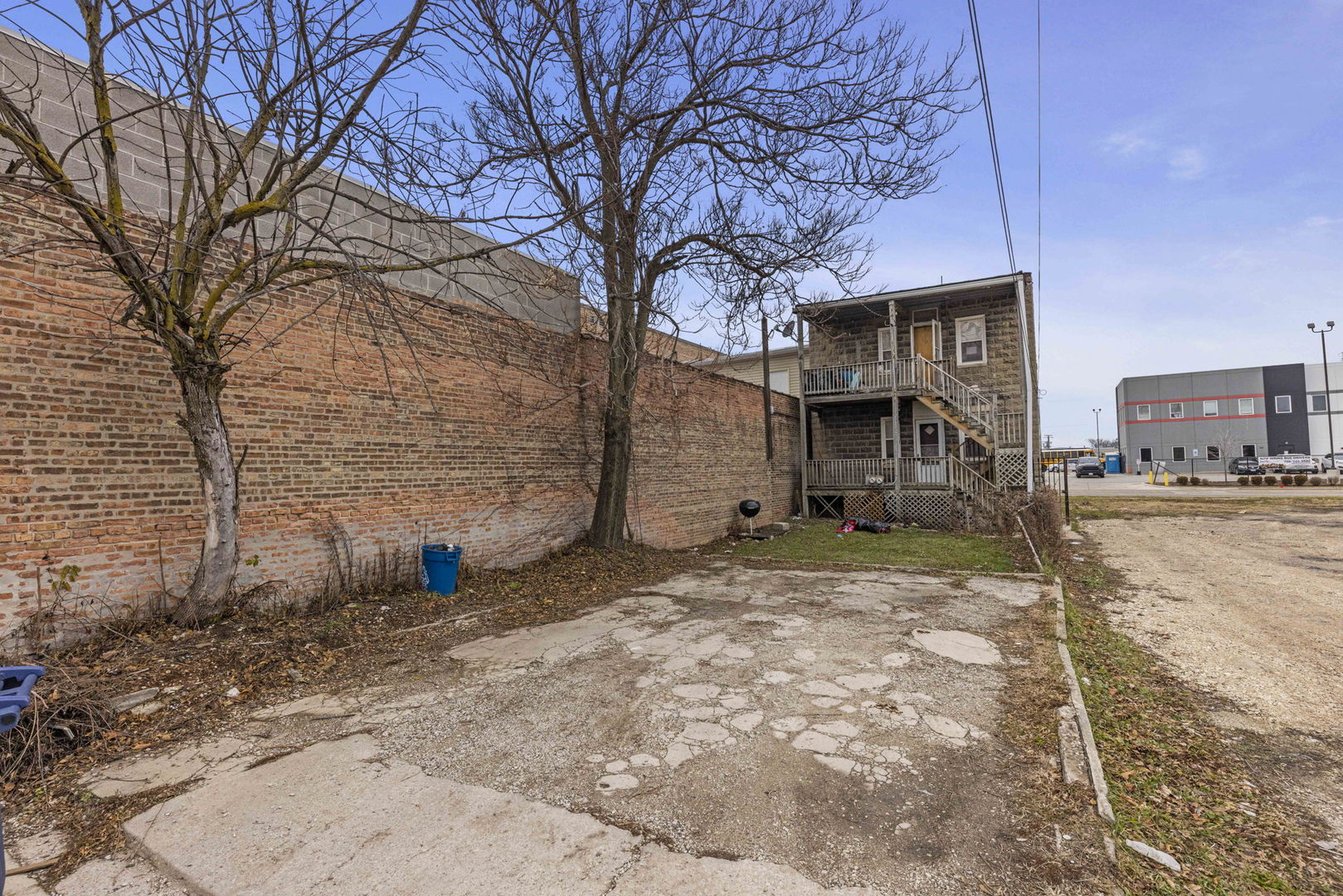 910 St Charles Road Maywood, IL 60153 - Photo 13 of 13 a view of a house with large tree and wooden fence