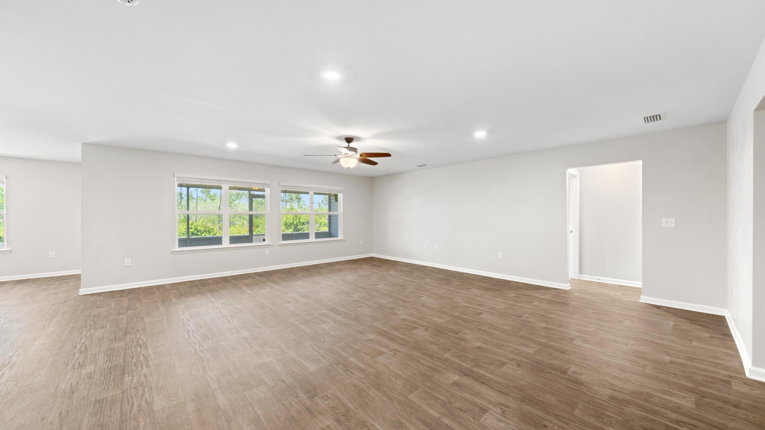 3927 Alva Thomas Road Panama City, FL 32404 - Photo 10 of 46 a view of room with window and wooden floor