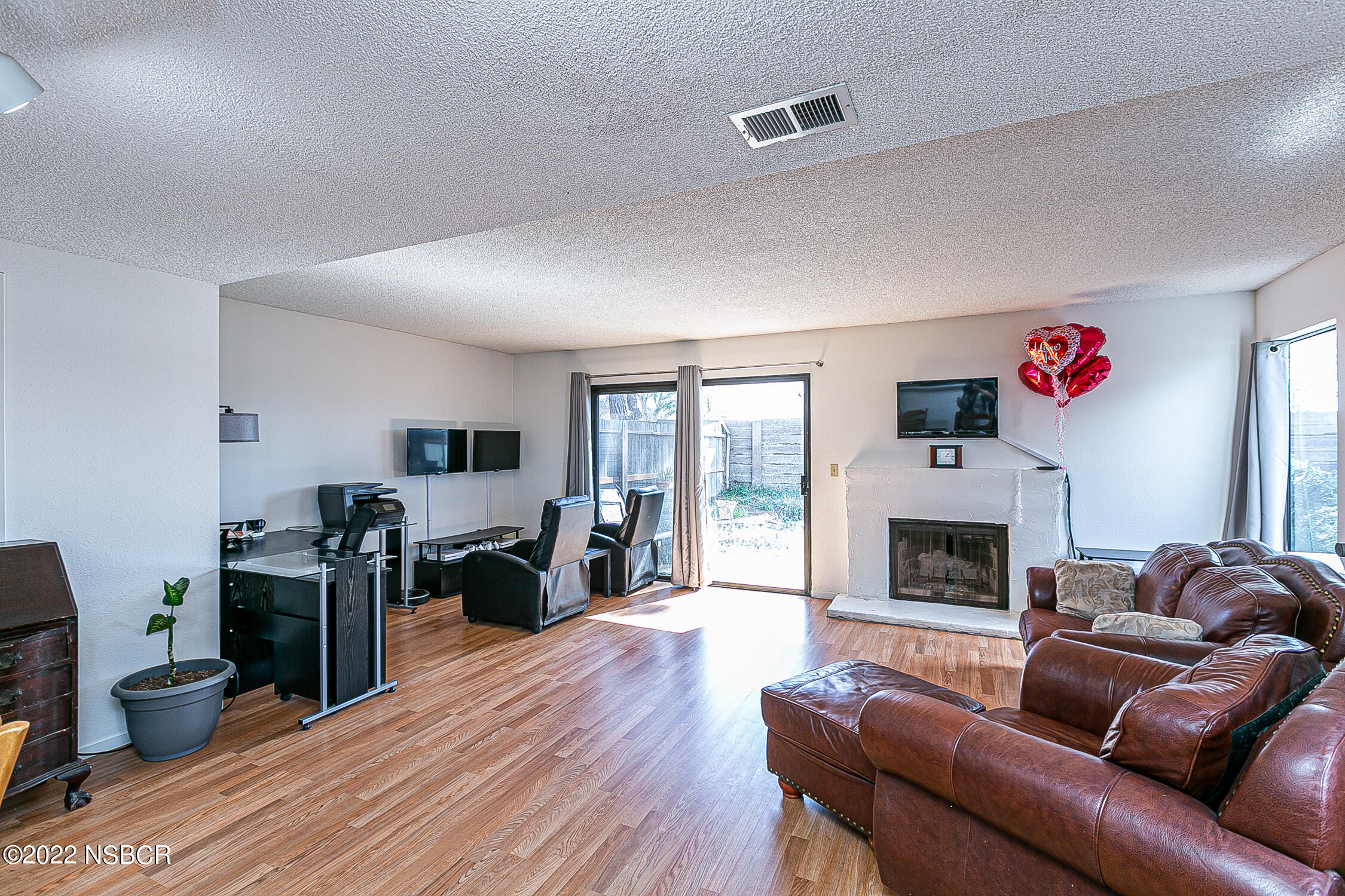 1210 East Foster Road, Unit B Santa Maria, CA 93455 - Photo 12 of 30 a living room with furniture and a fireplace