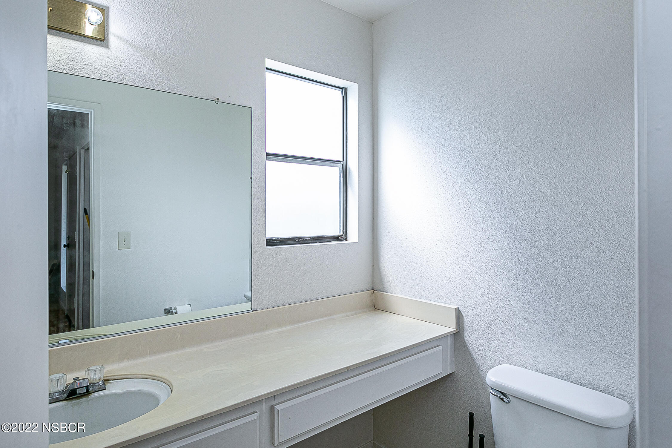 1210 East Foster Road, Unit B Santa Maria, CA 93455 - Photo 22 of 30 a bathroom with a sink toilet and window