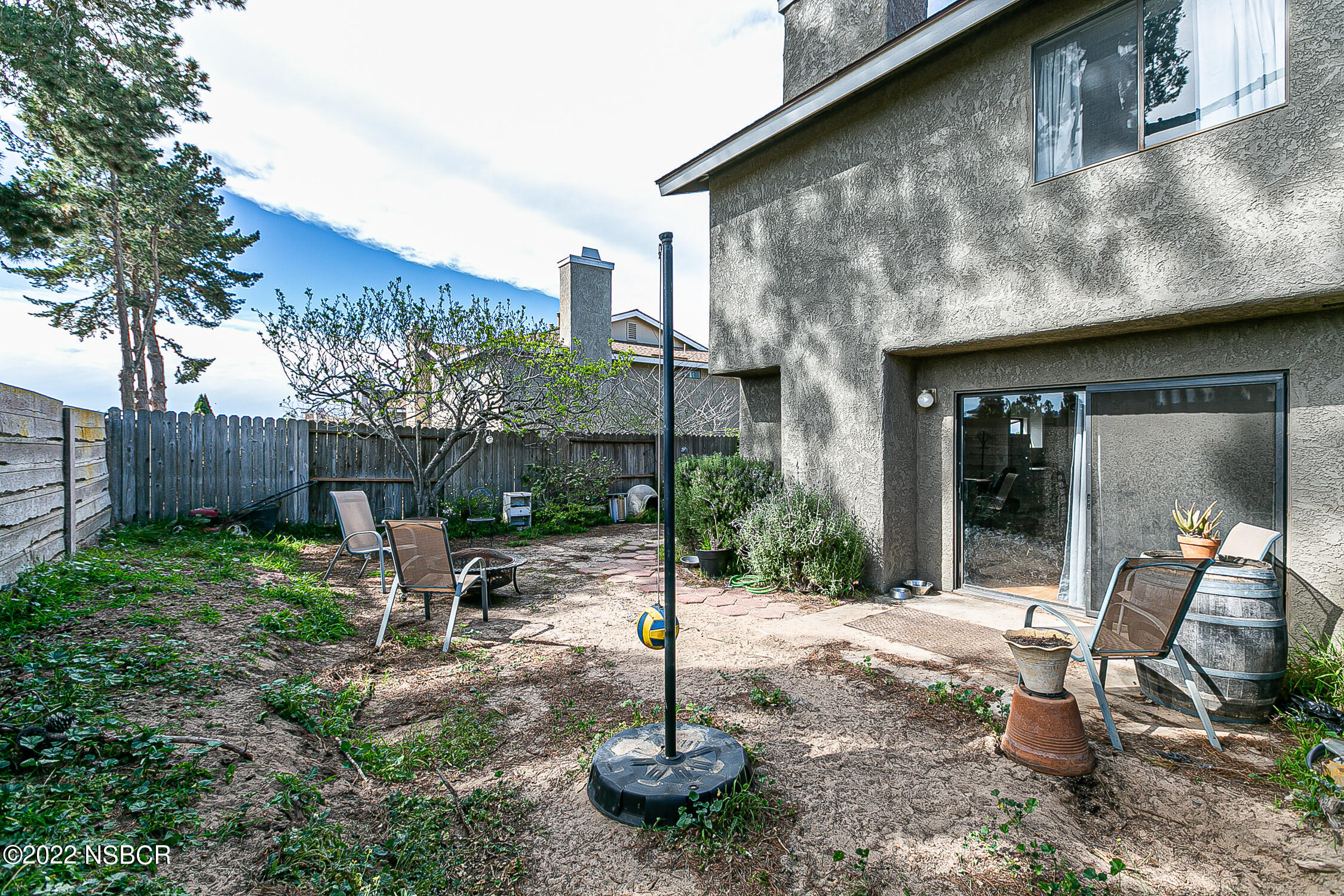 1210 East Foster Road, Unit B Santa Maria, CA 93455 - Photo 24 of 30 a view of a chair and table in backyard of the house