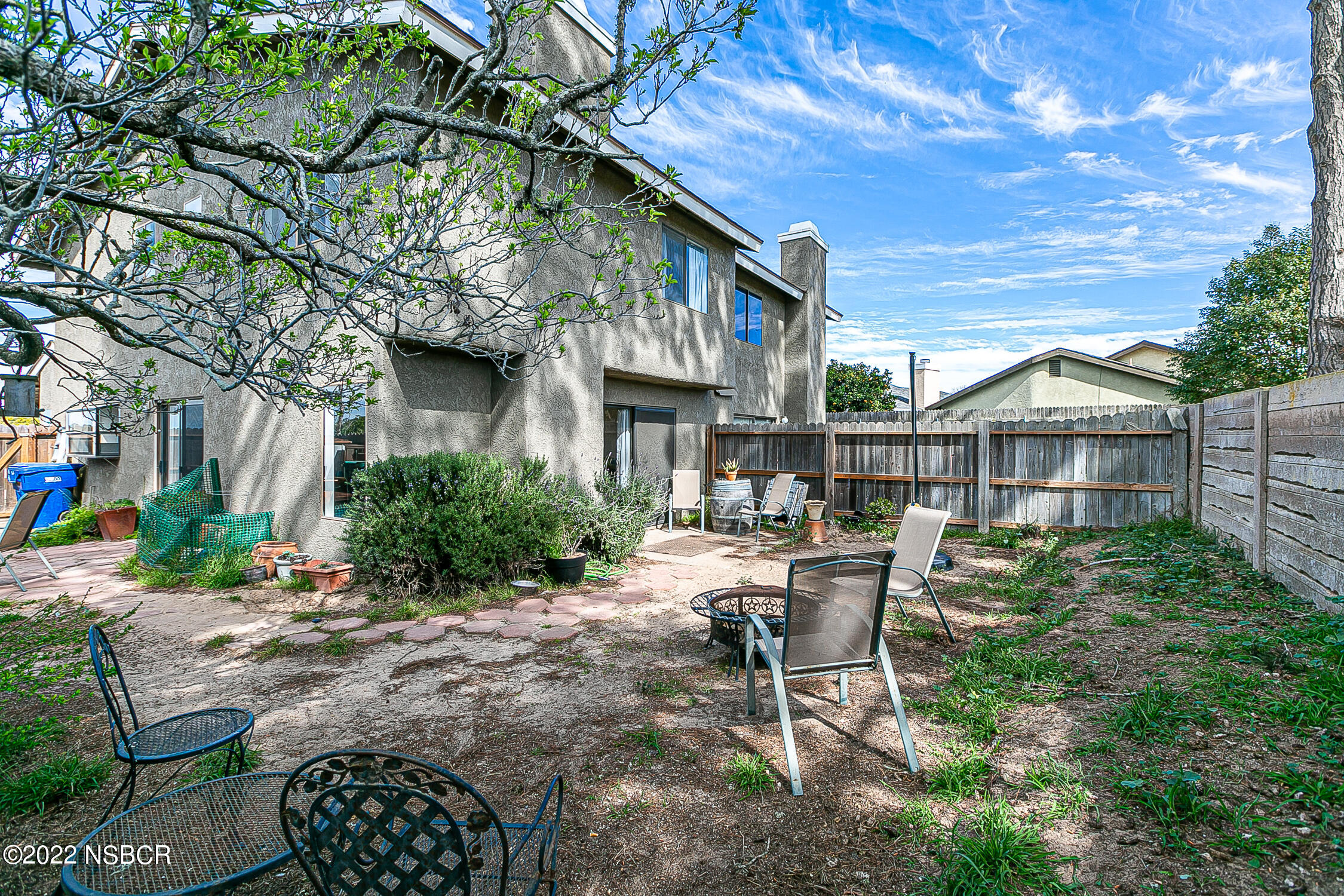 1210 East Foster Road, Unit B Santa Maria, CA 93455 - Photo 27 of 30 a view of a chair and table in backyard of the house