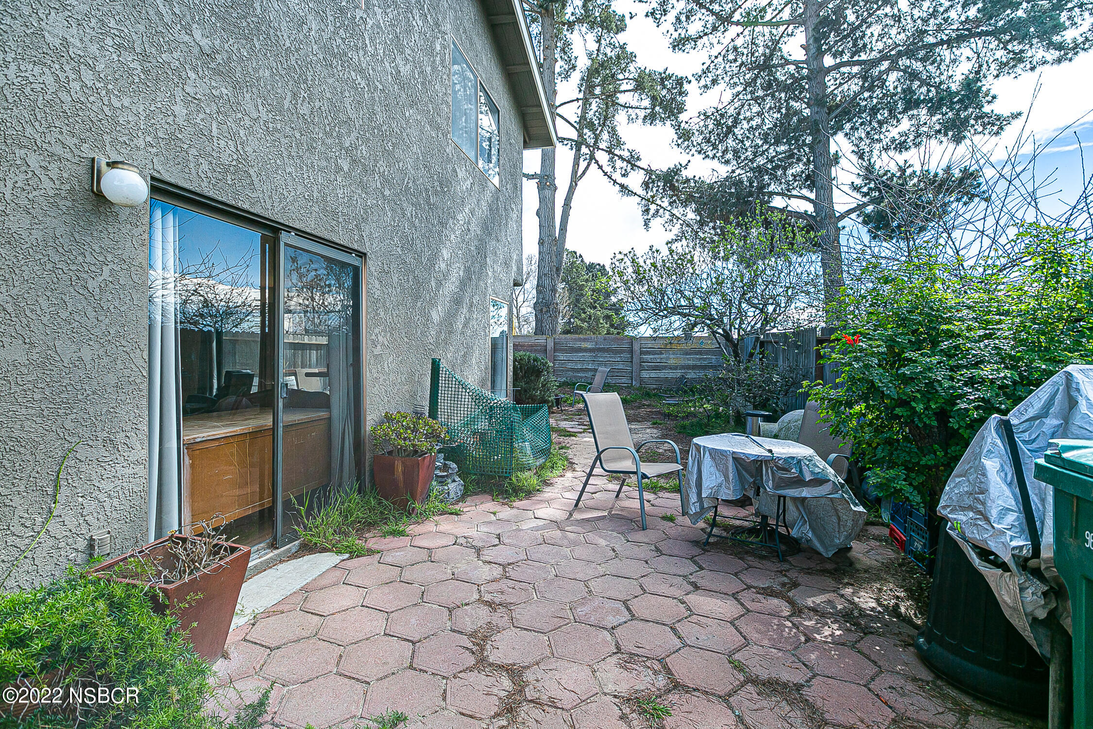 1210 East Foster Road, Unit B Santa Maria, CA 93455 - Photo 29 of 30 a view of backyard with a table and chairs and potted plants