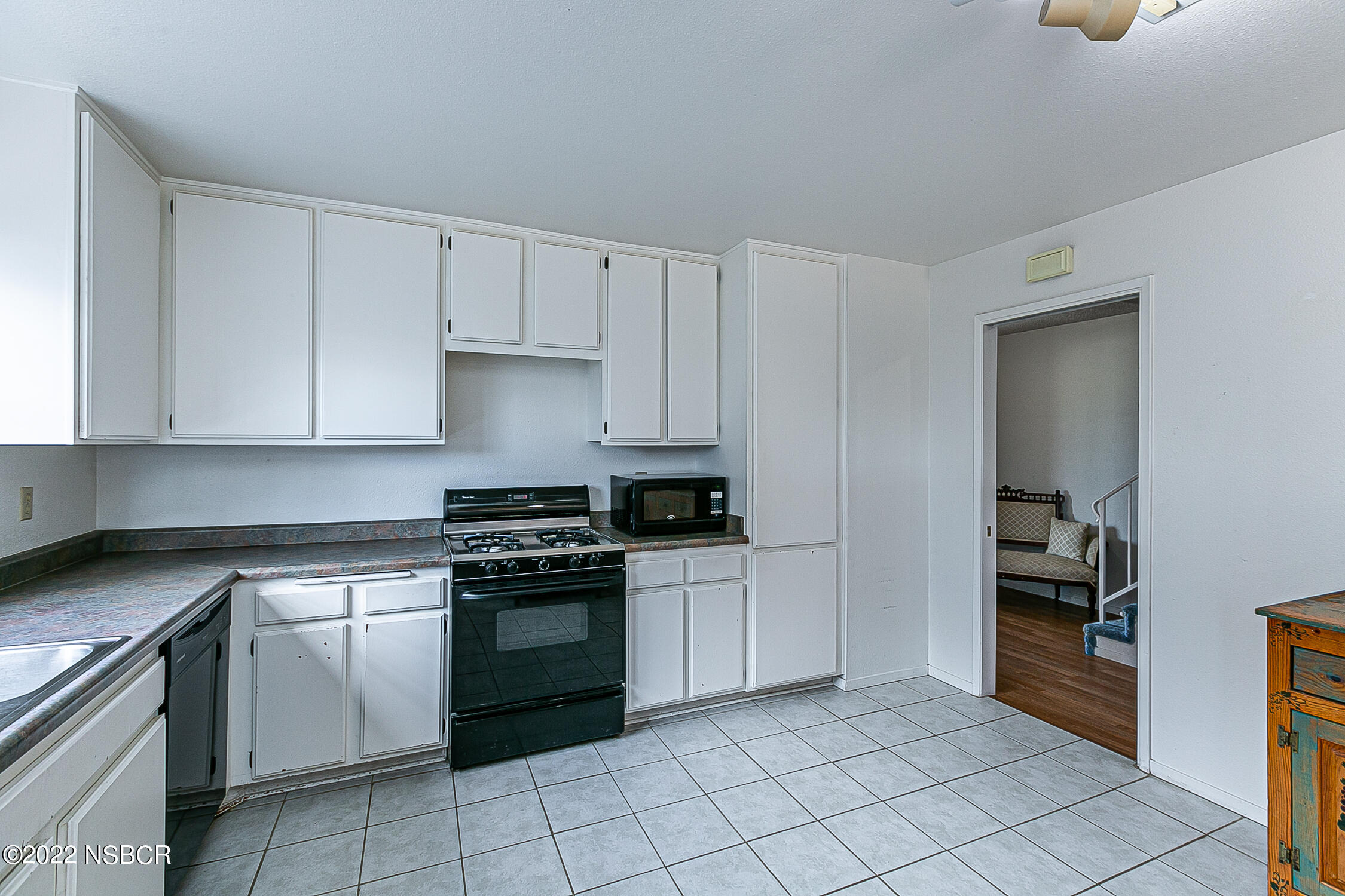 1210 East Foster Road, Unit B Santa Maria, CA 93455 - Photo 8 of 30 a kitchen with white cabinets and appliances