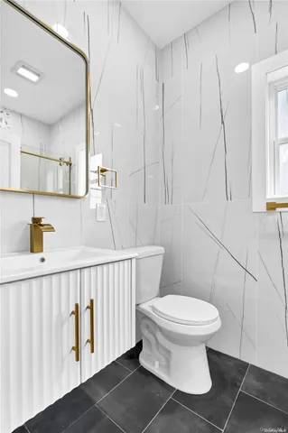 a bathroom with a toilet and a mirror