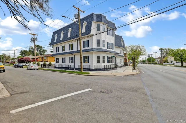 a city street lined with buildings and cars parked on the road