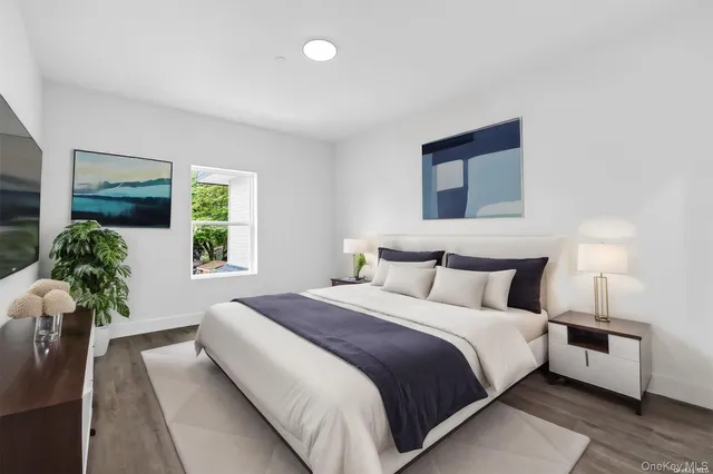 a bedroom with bed and a potted plant