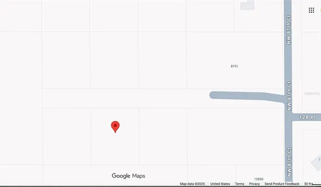 a white wall with a white comforter and a painting on it