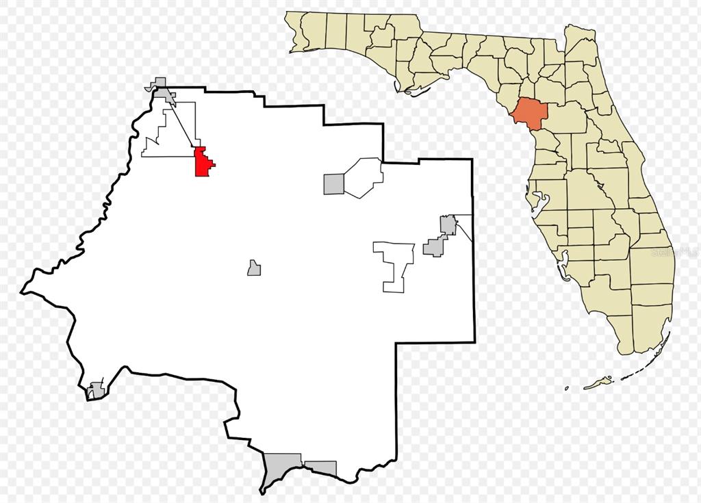 Tbd Chiefland, FL 32626 - Photo 3 of 4 a white wall with a white comforter and a painting on it