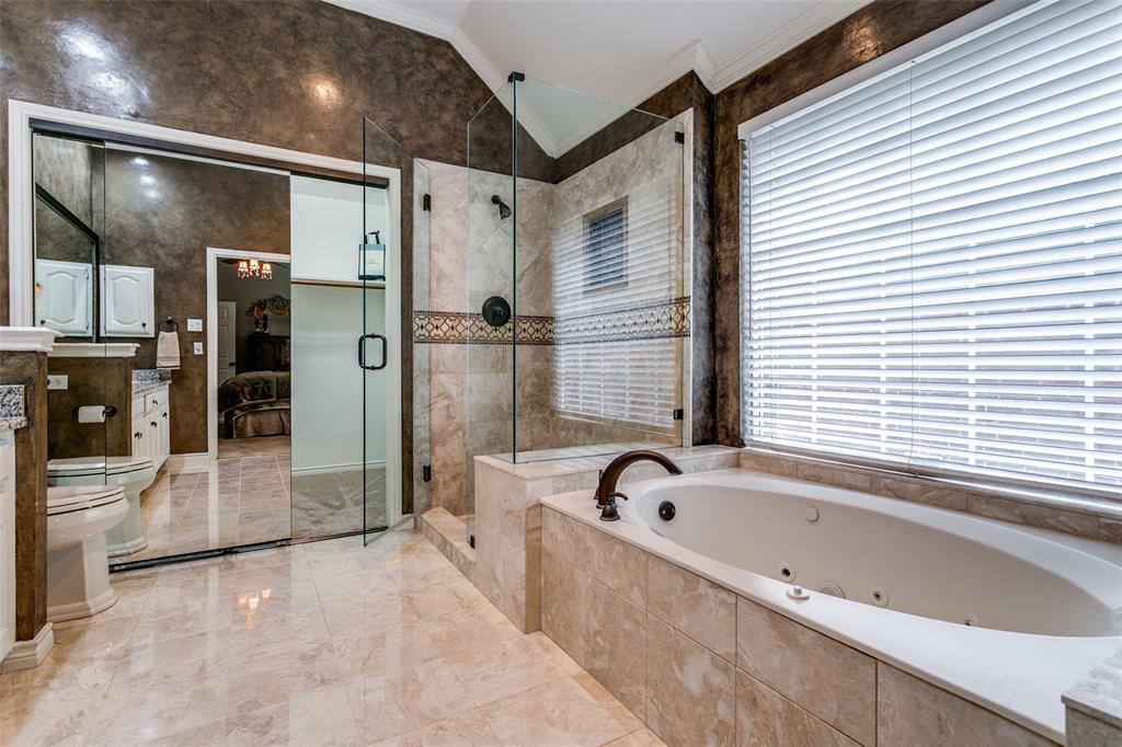 303 Old York Road Irving, TX 75063 - Photo 17 of 26 a bathroom with a bathtub and a shower