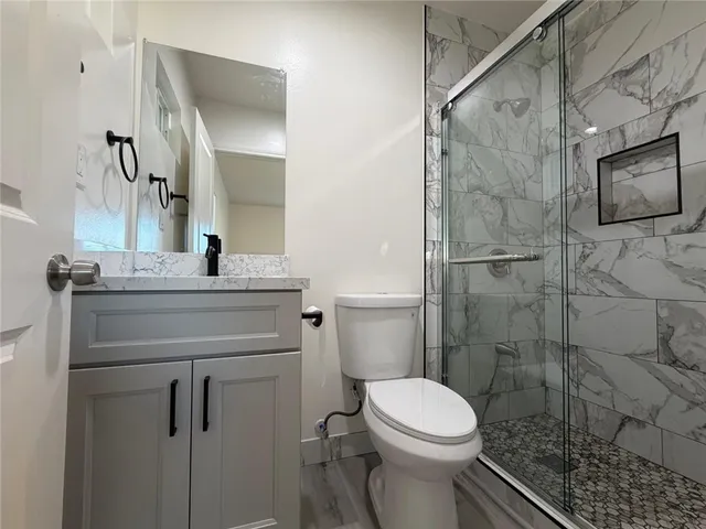 a bathroom with a sink toilet and shower