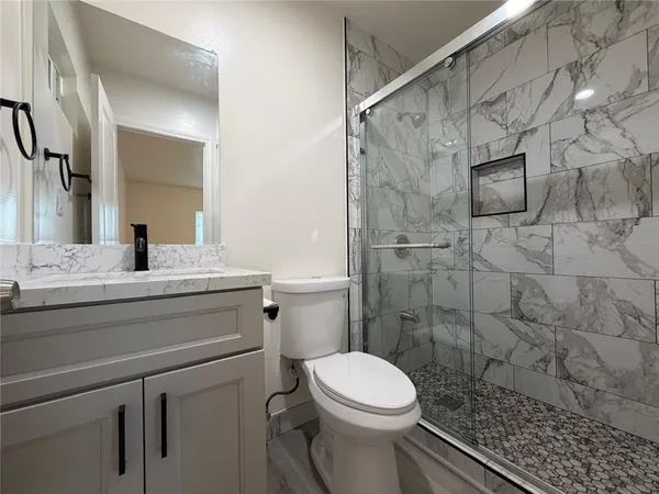 a view of a room with wooden floor and a window