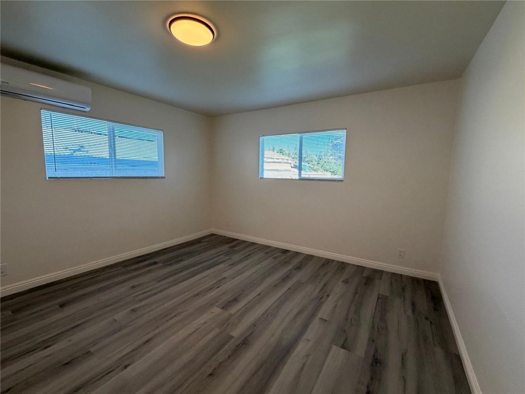 1316 Walnut Street San Gabriel, CA 91776 - Photo 13 of 19 an empty room with wooden floor and windows