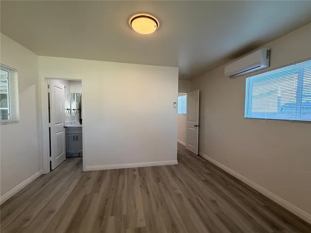 a view of a room with wooden floor and a sink