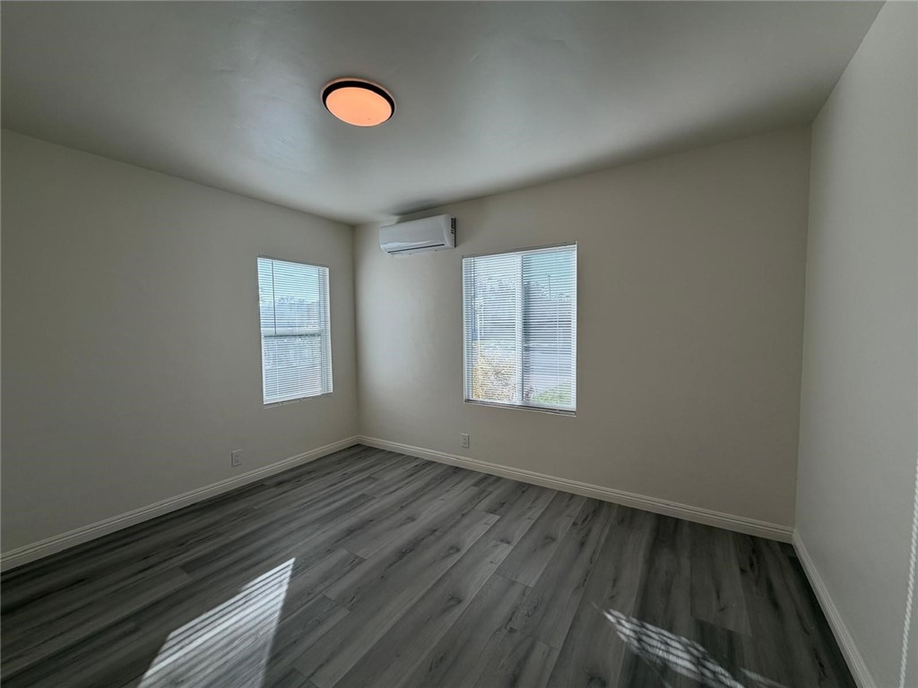 1316 Walnut Street San Gabriel, CA 91776 - Photo 7 of 19 a view of an empty room with wooden floor and a window