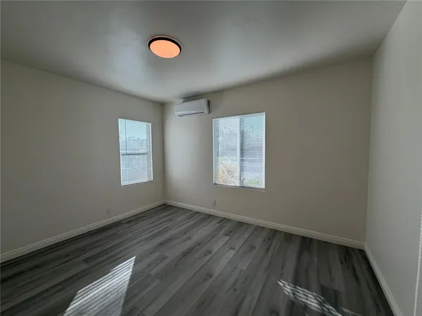 a view of a room with wooden floor