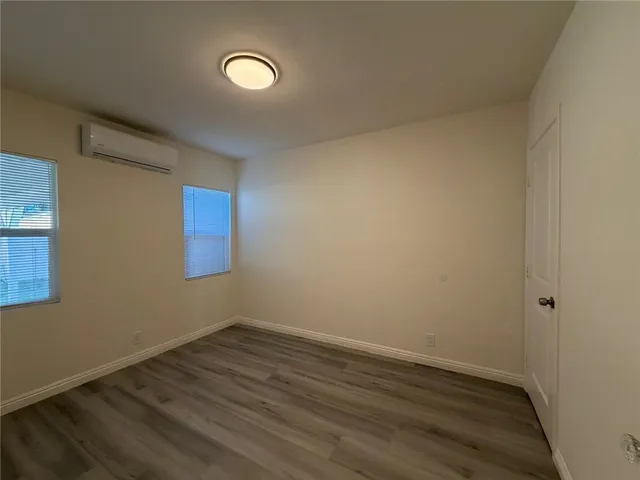 a view of a room with wooden floor and window