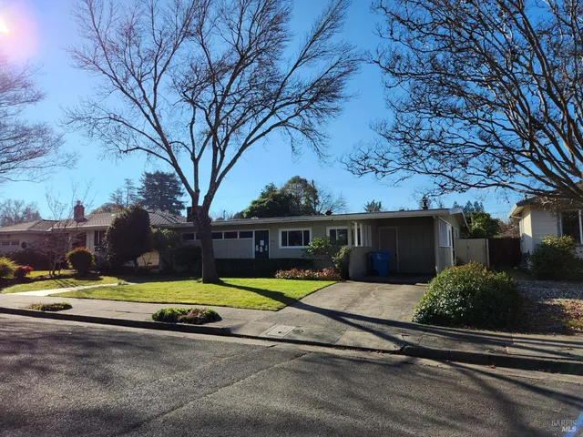 a view of a house with swimming pool and sitting area