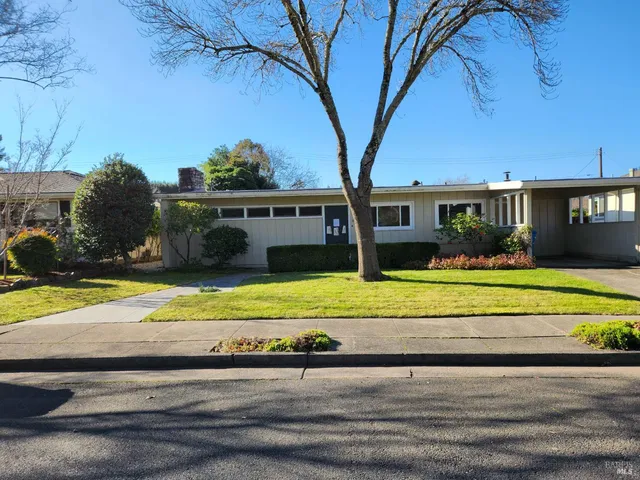 a view of house with outdoor space and swimming pool