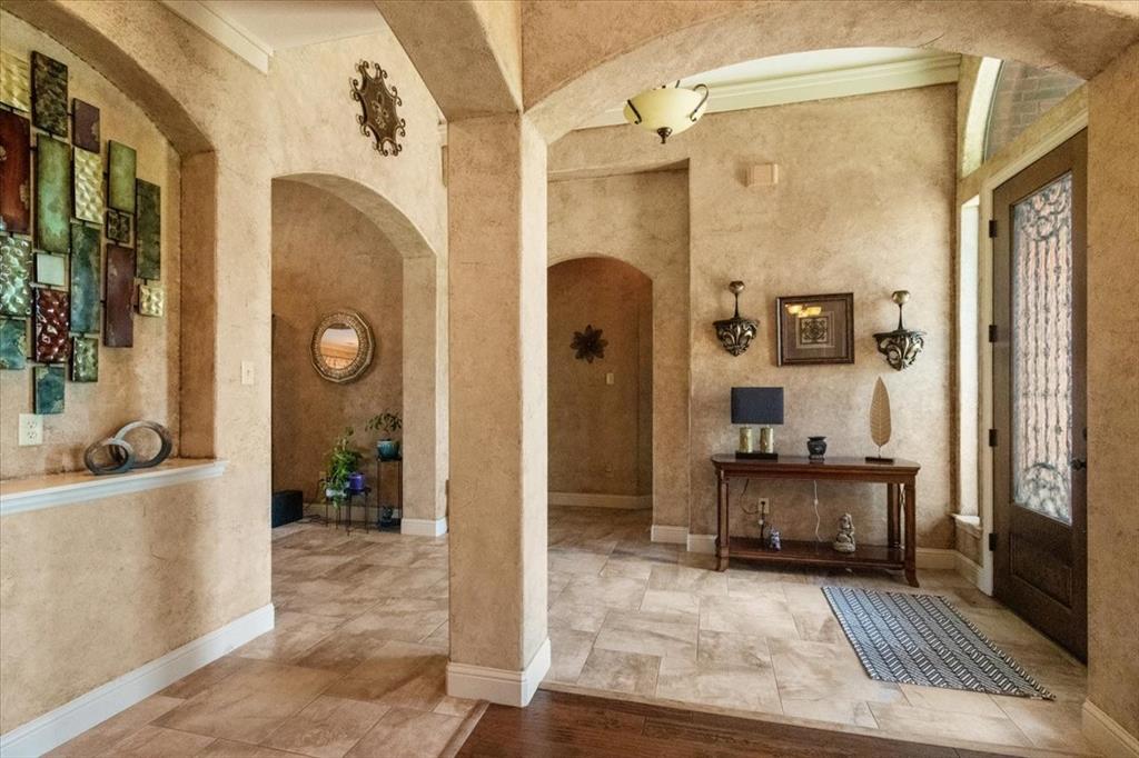 120 Trail Ridge Weatherford, TX 76087 - Photo 12 of 37 Main houseEntrance foyer featuring arched walkways, barrel ceiling, stone finish flooring, and formal dining