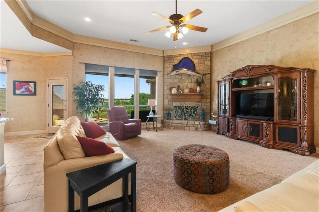 120 Trail Ridge Weatherford, TX 76087 - Photo 16 of 37 Living area featuring ceiling fan, a stone fireplace, recessed lighting, and carpet floors