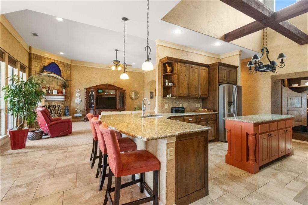 120 Trail Ridge Weatherford, TX 76087 - Photo 24 of 37 Kitchen open to breakfast area. Breakfast bar for dining and visiting . Kitchen is truly the heart of the home!