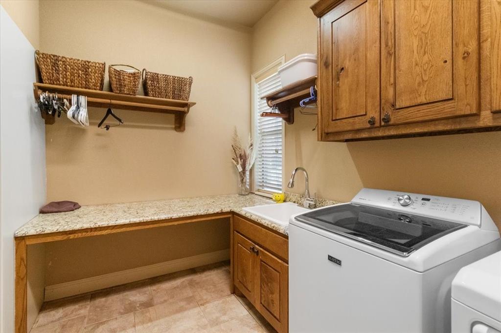 120 Trail Ridge Weatherford, TX 76087 - Photo 30 of 37 Laundry room with counter for folding clothes or make it your office space, cabinet space, washer and dryer, and deep sink