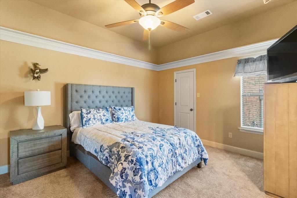 120 Trail Ridge Weatherford, TX 76087 - Photo 37 of 37 bedroom with ceiling fan and walk in closet with adjoining bath area to another bedroom.