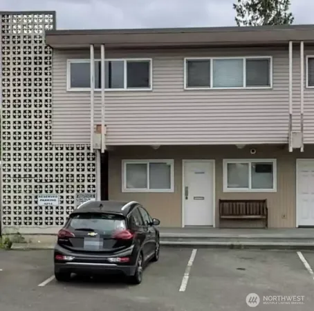 a car parked in front of a white building