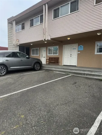 a view of a car parked front of a house
