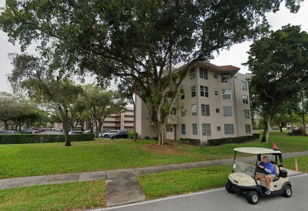 a car parked in front of a house with a yard