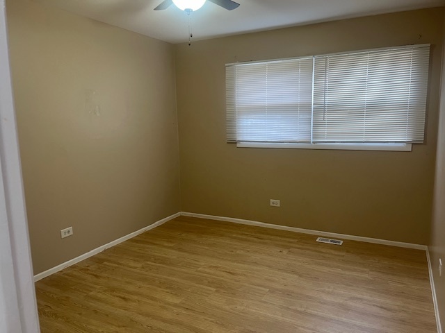 3045 Central Road Glenview, IL 60025 - Photo 11 of 15 a view of an empty room with wooden floor and a window