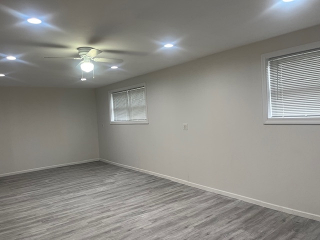 3045 Central Road Glenview, IL 60025 - Photo 14 of 15 an empty room with wooden floor ceiling fan and windows