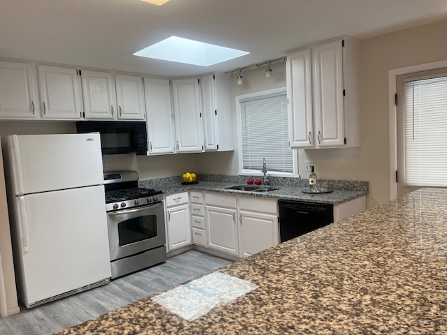 3045 Central Road Glenview, IL 60025 - Photo 2 of 15 a kitchen with granite countertop a sink stove and refrigerator