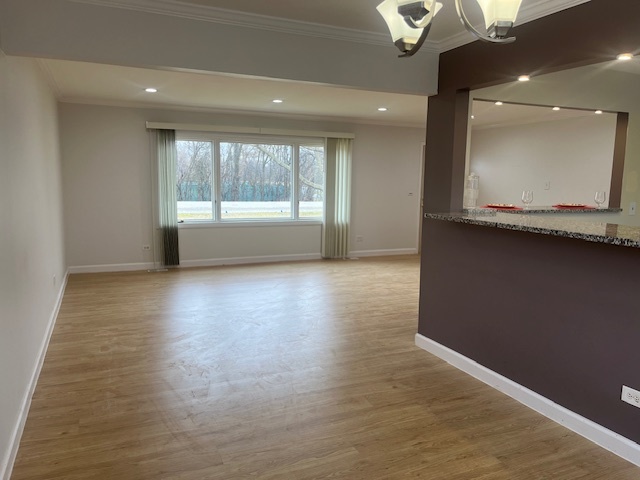 3045 Central Road Glenview, IL 60025 - Photo 7 of 15 a view of an empty room with wooden floor and a window