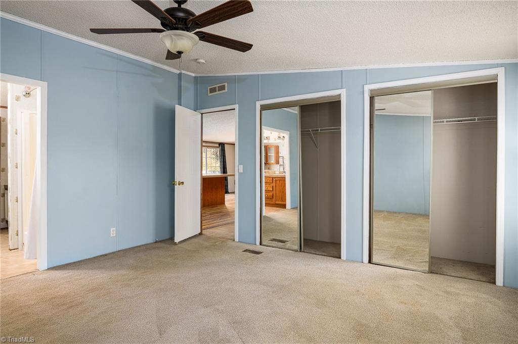 876 Mr Henry Road Mocksville, NC 27028 - Photo 13 of 41 Primary bedroom with dual closets and ensuite