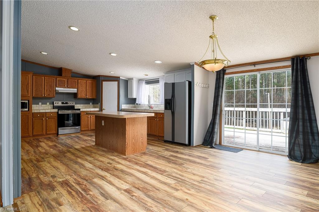 876 Mr Henry Road Mocksville, NC 27028 - Photo 7 of 41 Kitchen boasts new LVP flooring, and tile countertops!