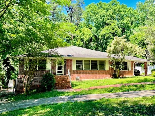 2396 Lavista Road Northeast Atlanta, GA 30329 - Photo 1 of 28 front view of a house with a yard