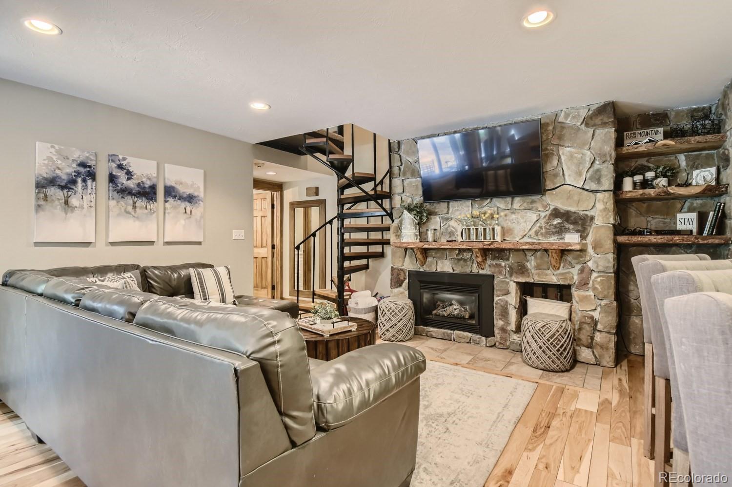 1937 Soda Ridge Road, Unit 1153/1154 Dillon, CO 80435 - Photo 2 of 17 a living room with furniture a fireplace and a flat screen tv