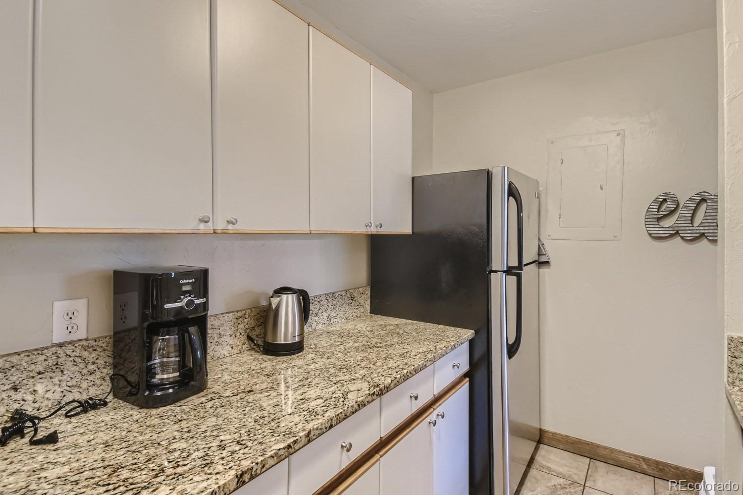 1937 Soda Ridge Road, Unit 1153/1154 Dillon, CO 80435 - Photo 6 of 17 a kitchen with stainless steel appliances granite countertop a sink refrigerator and stove
