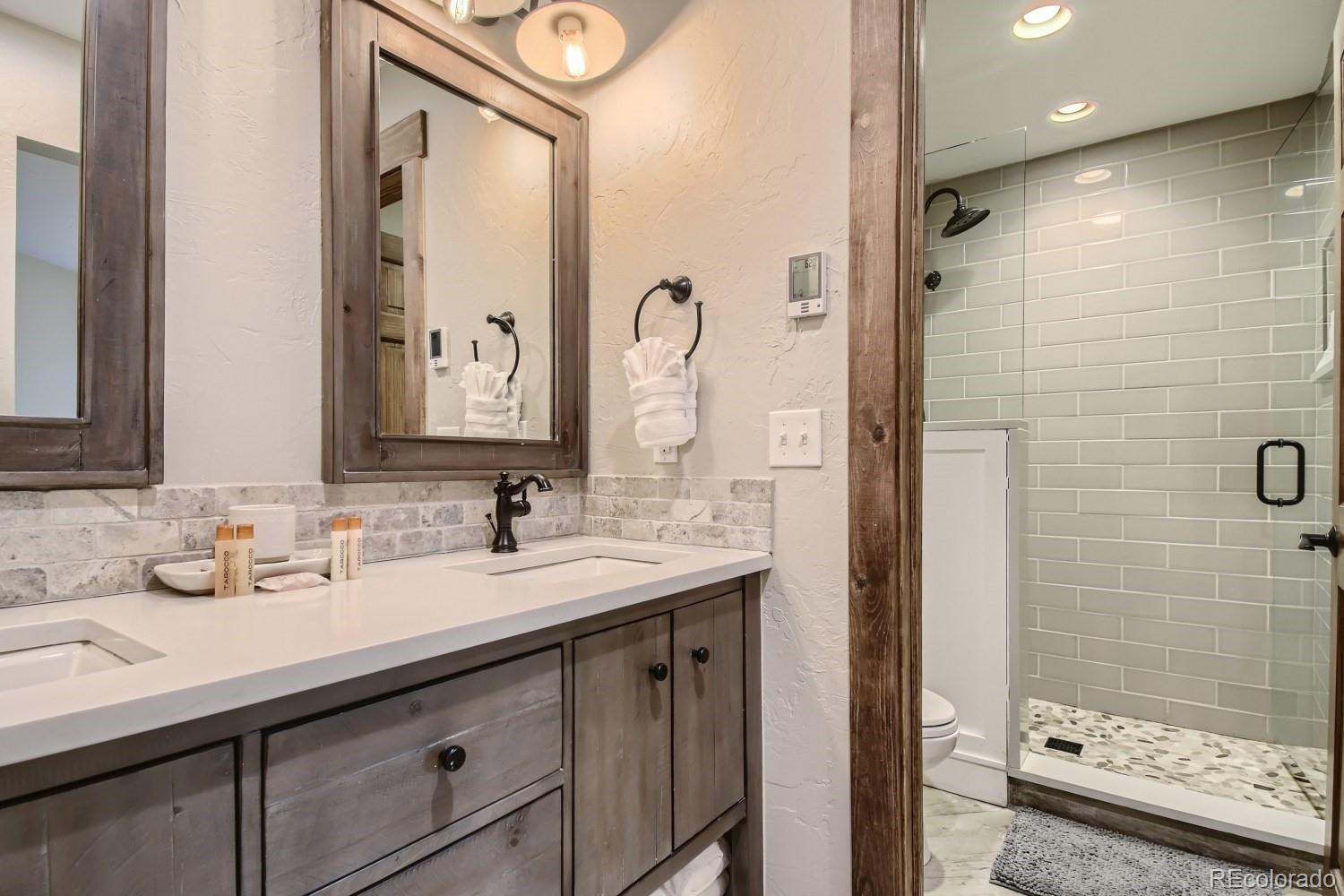 1937 Soda Ridge Road, Unit 1153/1154 Dillon, CO 80435 - Photo 8 of 17 a bathroom with a sink a double vanity and shower