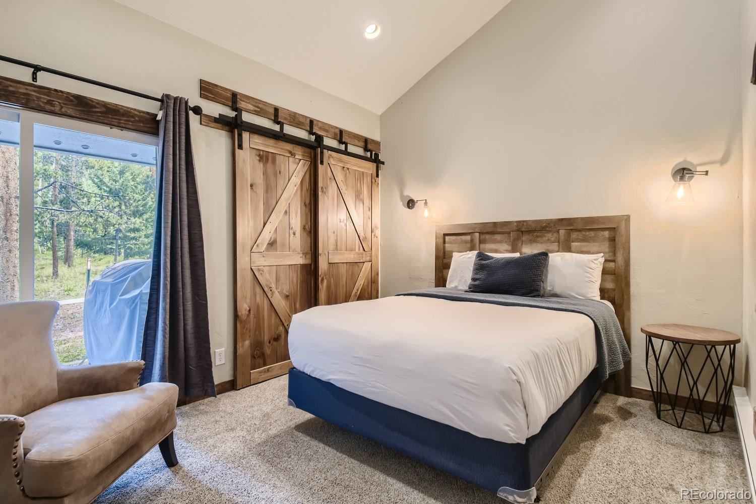 1937 Soda Ridge Road, Unit 1153/1154 Dillon, CO 80435 - Photo 9 of 17 a bedroom with a bed and a couch