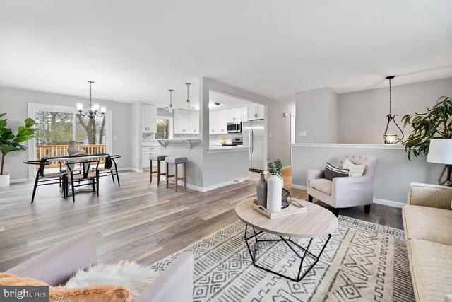 a living room with furniture and kitchen view