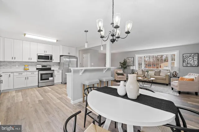 a view of a dining room with furniture wooden floor and chandelier