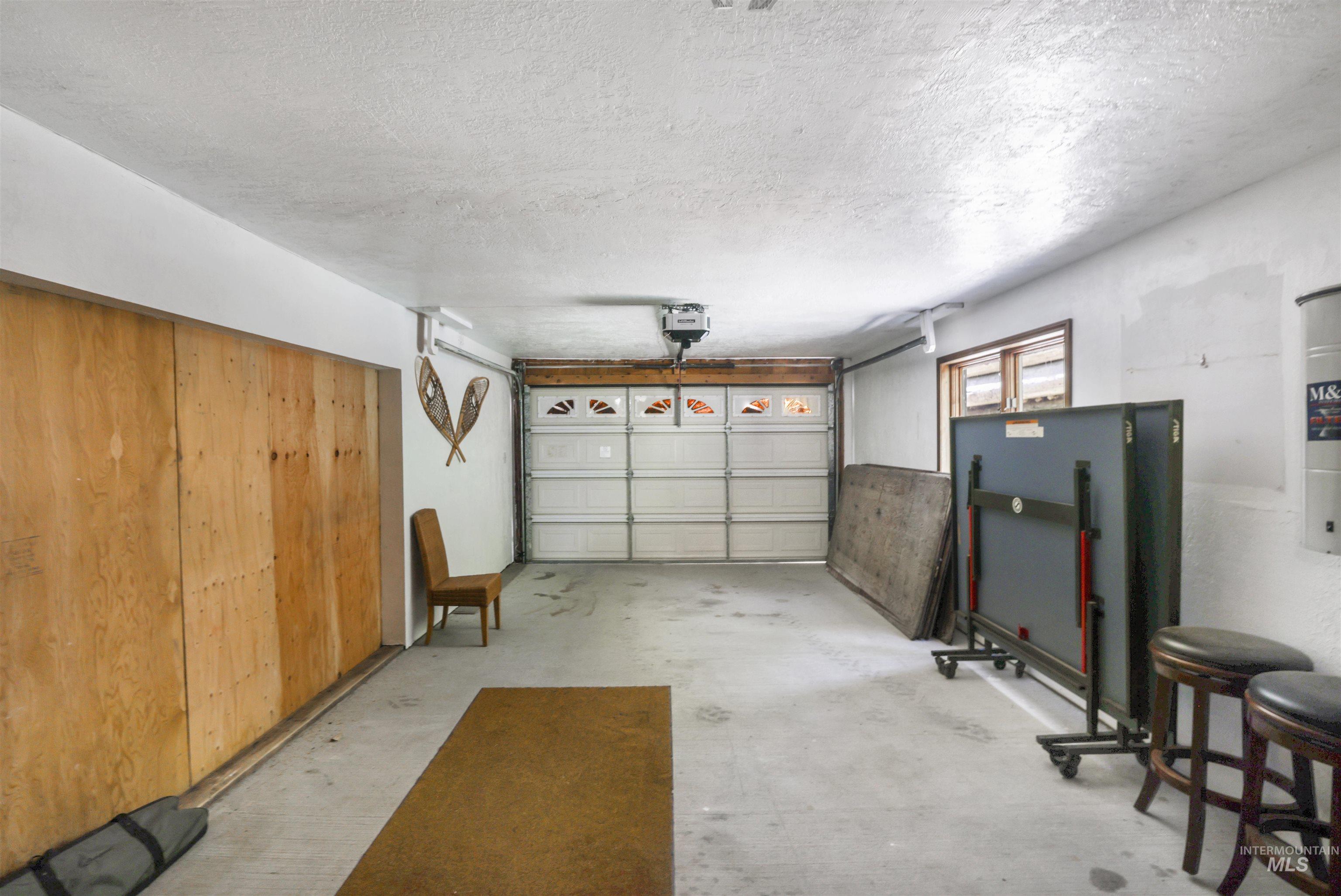 224 Dakota Road Mountain Home, ID 83647 - Photo 33 of 50 Spacious garage featuring a concrete floor, overhead lighting, and an automatic garage door opener