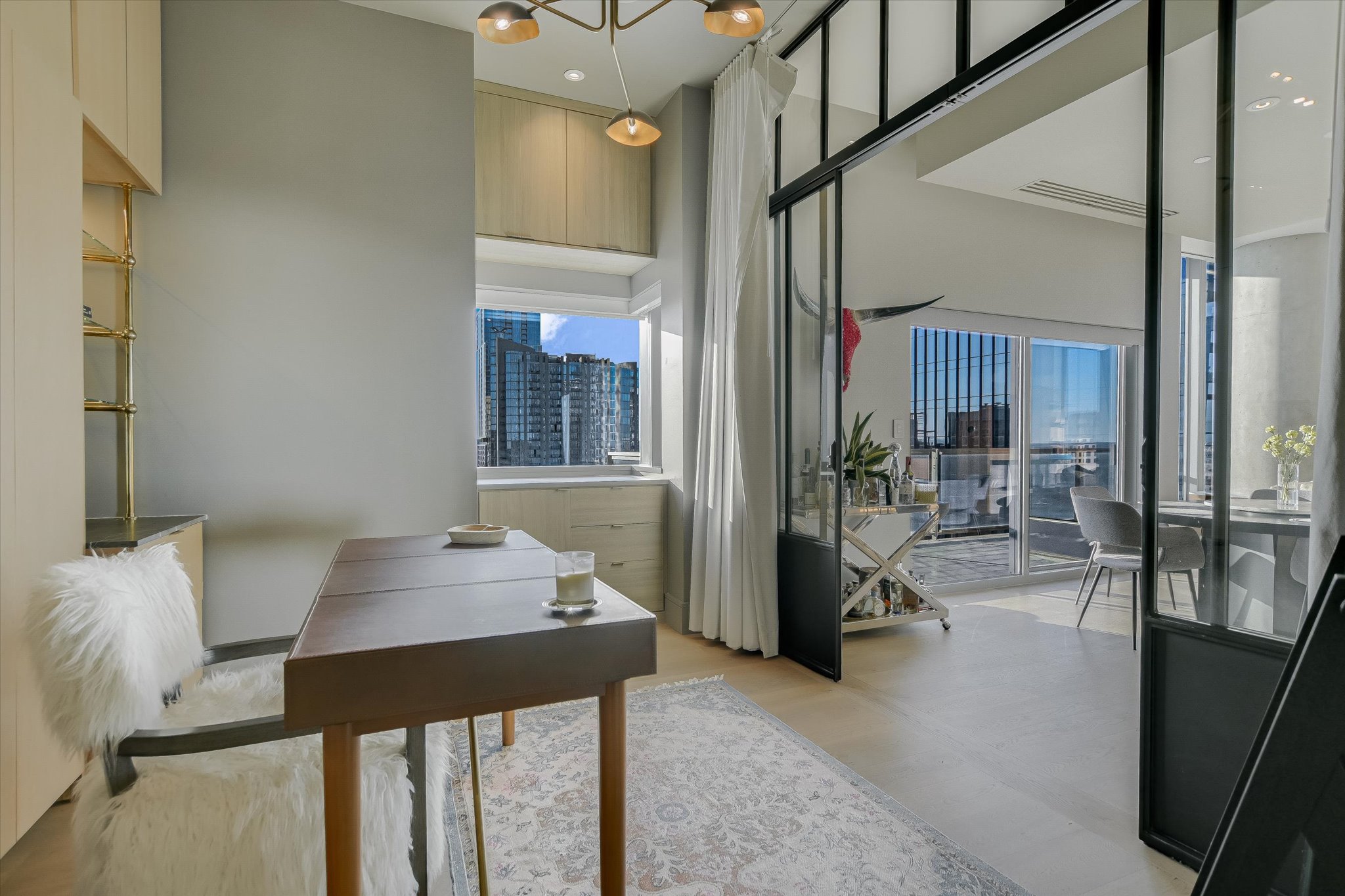 210 Lavaca Street, Unit 3108 Austin, TX 78701 - Photo 29 of 34 a view of a dining room with furniture and a chandelier
