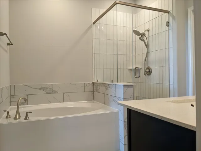 a bathroom with a bathtub and a shower